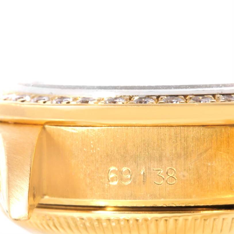 This image shows a close-up of the side of the Rolex President 69138 Women's Yellow Gold Champagne Dial 69138 Women's Yellow Gold Champagne Dial model watch, highlighting the case and serial number.