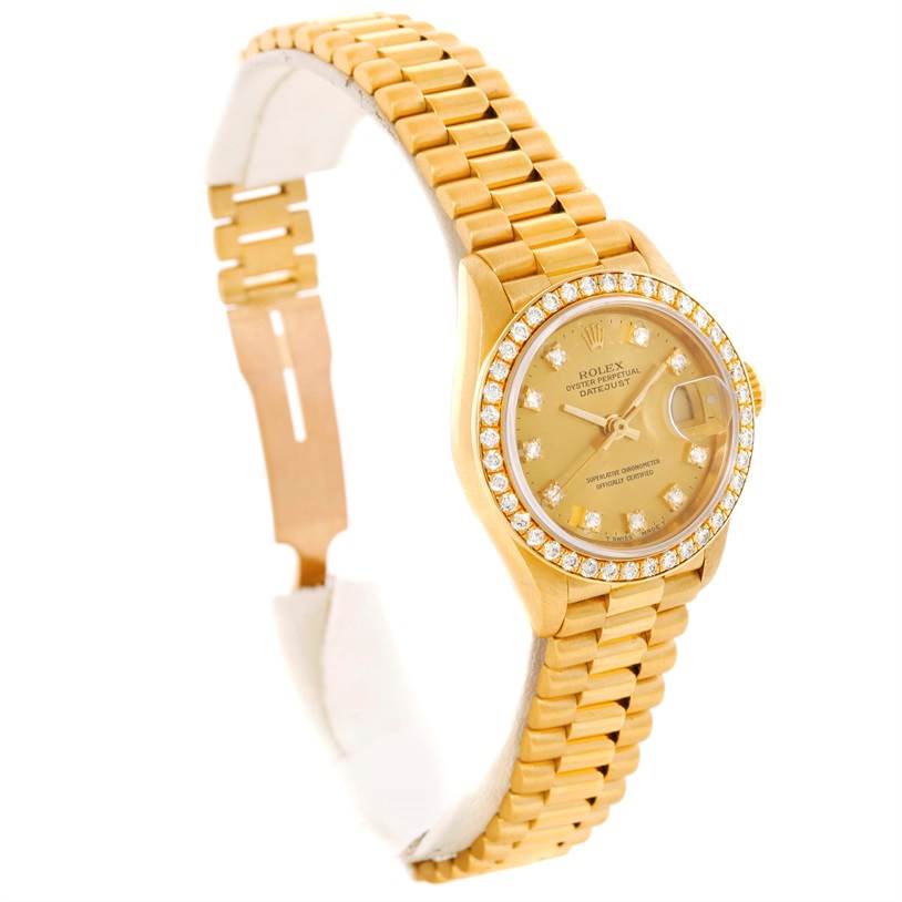The image shows a gold Rolex President 69138 Women's Yellow Gold Champagne Dial 69138 Women's Yellow Gold Champagne Dial model watch from a left-front angle, highlighting its bracelet and diamond-studded bezel.