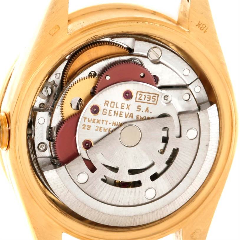 This is an interior view of the Rolex President 69138 Women's Yellow Gold Champagne Dial 69138 Women's Yellow Gold Champagne Dial 2135 model, displaying its intricate mechanical movement components.