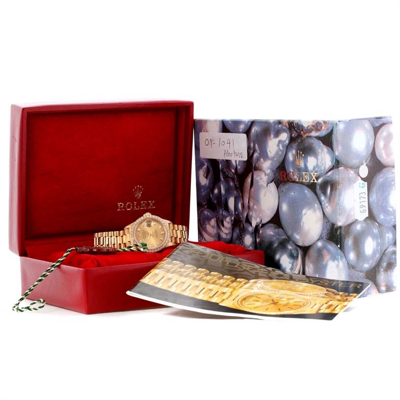 This image shows a Rolex President 69138 Women's Yellow Gold Champagne Dial 69138 Women's Yellow Gold Champagne Dial model watch inside a red box, accompanied by booklets and a pearl-themed outer box.