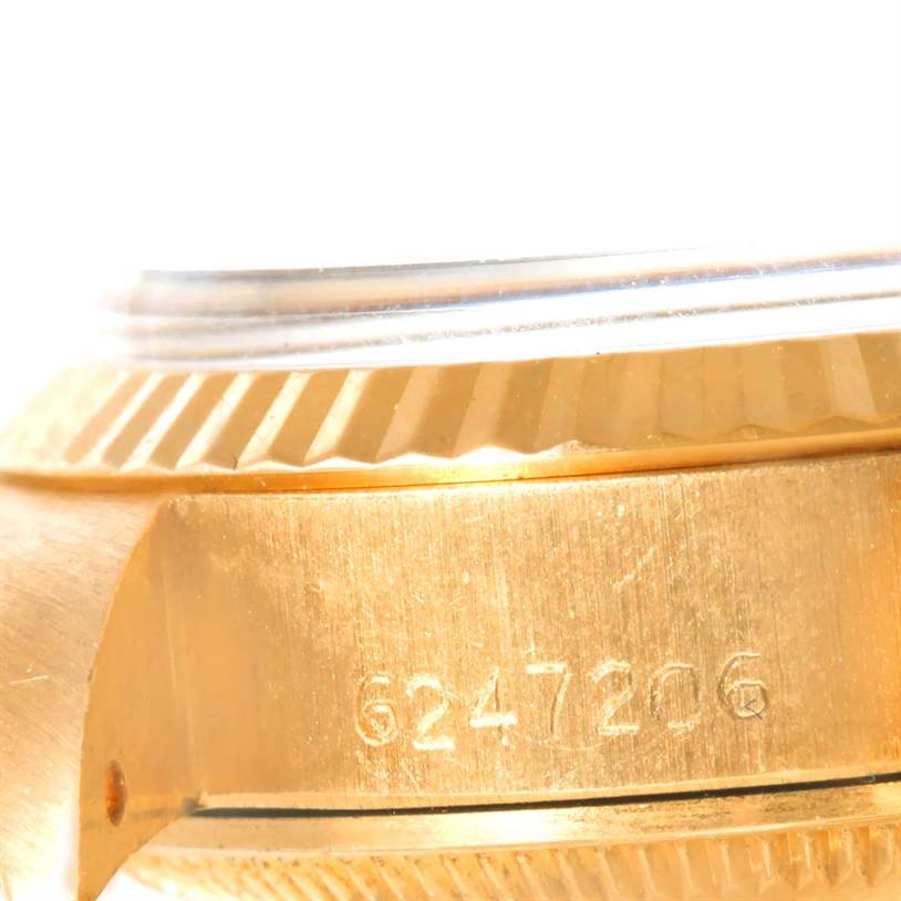 Close-up side view of a Rolex President 6917 Women's Yellow Gold White Dial 6917 Women's Yellow Gold White Dial model watch, showing the watch case with serial number engraving.