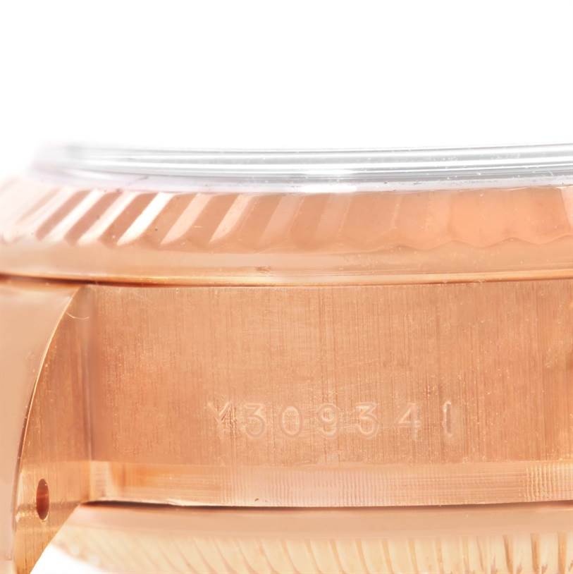 This close-up image of a Rolex President 179175 Women's Rose Gold Pink Dial 179175 Women's Rose Gold Pink Dial model watch shows the side casing with visible engraved serial numbers.