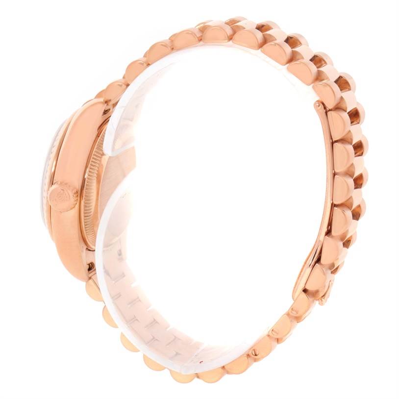 This image shows a side profile of a Rolex President 179175 Women's Rose Gold Pink Dial 179175 Women's Rose Gold Pink Dial watch, highlighting the crown and a portion of the bracelet.