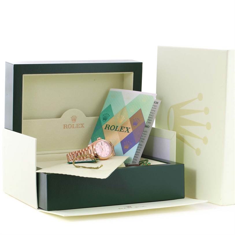 The image shows a President model Rolex watch in its box with accompanying papers and accessories.