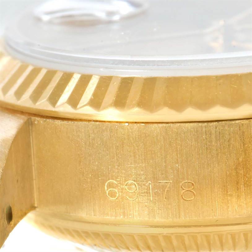 This close-up image shows the side view of the case and bezel of a Rolex President 69178 Women's Yellow Gold Champagne Dial 69178 Women's Yellow Gold Champagne Dial model, with the reference number engraved.