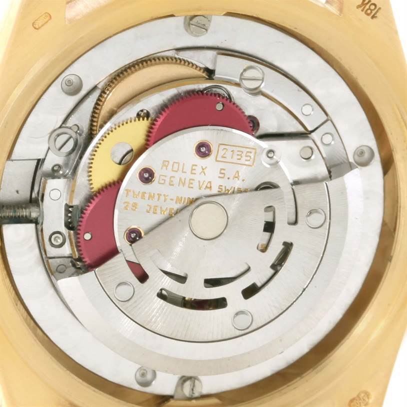The image shows the internal mechanism of a Rolex President 68278 Men
s Yellow Gold Champagne Dial 68278 Men
s Yellow Gold Champagne Dial model watch, including gears, screws, and the movement assembly.