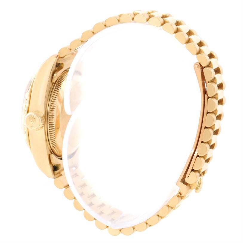 This image shows a side view of the Rolex President 79258 Women's Yellow Gold Champagne Dial 79258 Women's Yellow Gold Champagne Dial model watch, highlighting the crown and bracelet links.