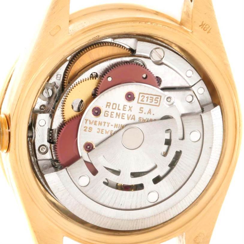 The image shows the internal mechanism of a Rolex President 69138 Women
s Yellow Gold Pink Dial 69138 Women
s Yellow Gold Pink Dial model watch, including gears and the rotor.