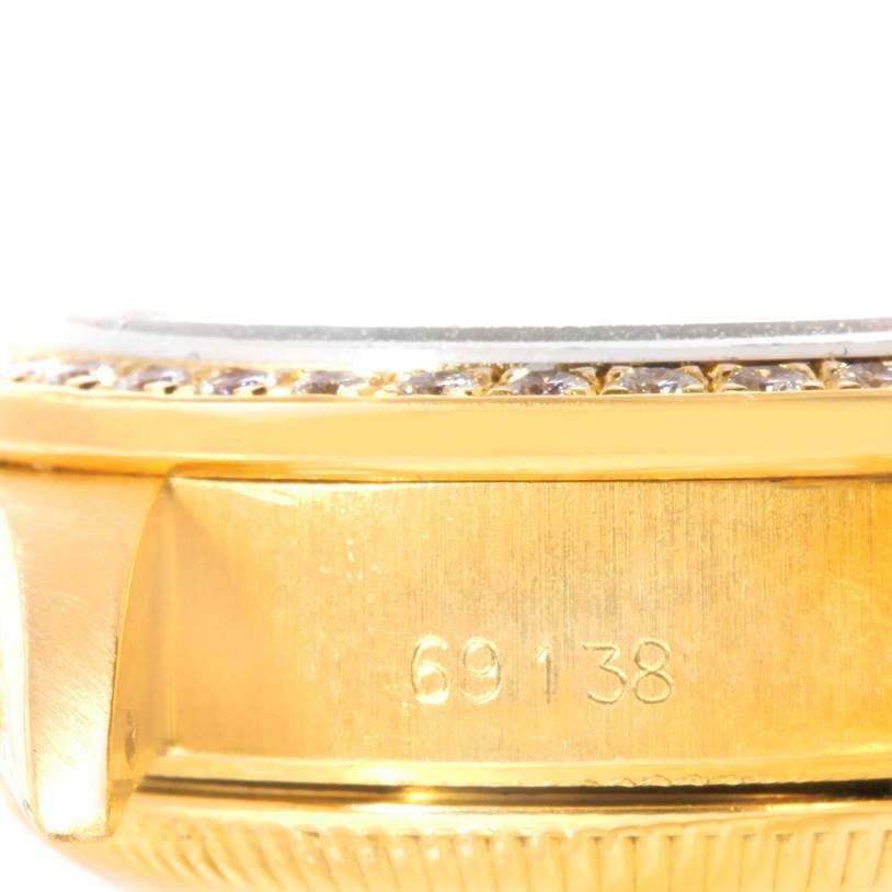 This close-up shot of the Rolex President 69138 Women
s Yellow Gold Pink Dial 69138 Women
s Yellow Gold Pink Dial model shows the watch
s side and case number "69138".