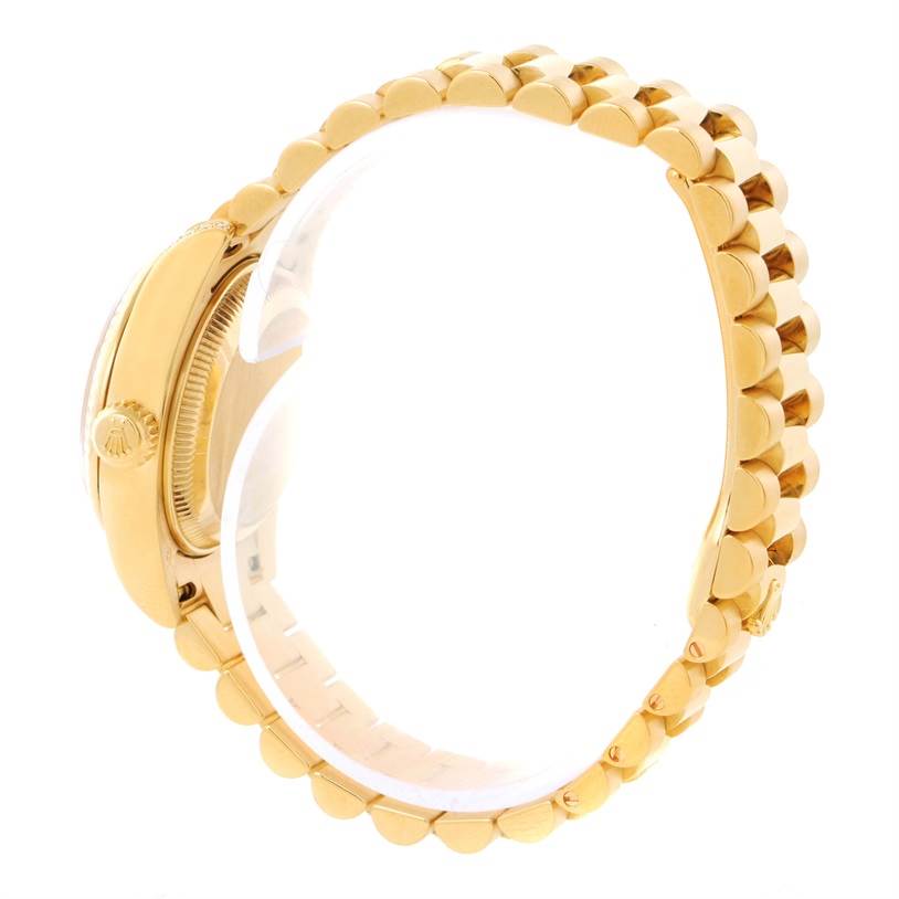 This side view shows the gold case, crown, and partial bracelet of the Rolex President 179238 Women
s Yellow Gold Mother of Pearl Dial 179238 Women
s Yellow Gold Mother of Pearl Dial model watch.