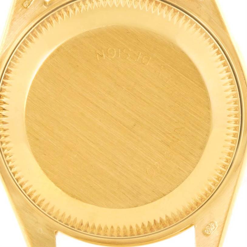 The image shows the back case of a Rolex President 69158 Women's Yellow Gold Black Dial 69158 Women's Yellow Gold Black Dial watch from a top-down angle.