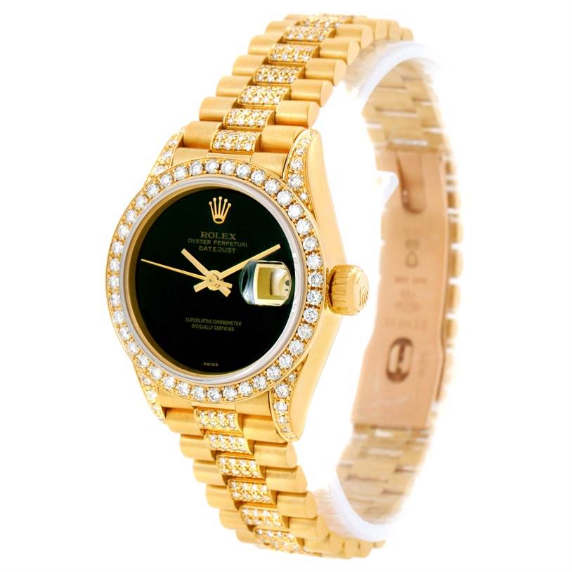 This image shows a Rolex President 69158 Women's Yellow Gold Black Dial 69158 Women's Yellow Gold Black Dial Datejust watch from a front angle, highlighting its gold bracelet, diamond bezel, and black dial.