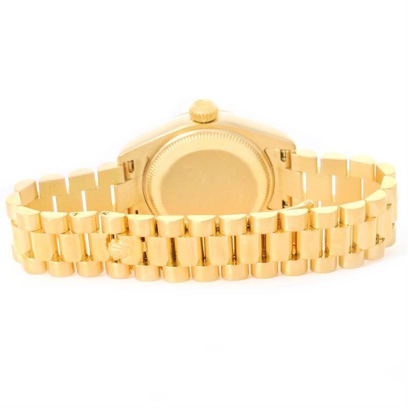 This image shows the backside of a Rolex President 179178 Women's Yellow Gold Champagne Dial 179178 Women's Yellow Gold Champagne Dial model watch, highlighting the case back and gold bracelet.