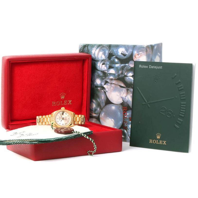 This Rolex President 179178 Women's Yellow Gold Champagne Dial 179178 Women's Yellow Gold Champagne Dial watch model is displayed front-facing in a red box, alongside its packaging and manual.