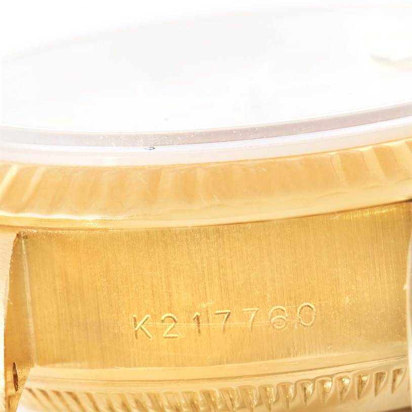 The image shows a close-up of the side of a Rolex President 79178 Women's Yellow Gold Beige Dial 79178 Women's Yellow Gold Beige Dial watch, highlighting the serial number and part of the gold case.