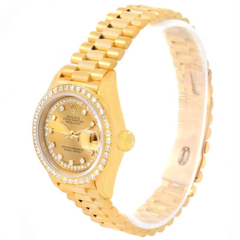 This is a Rolex President 69138 Women's Yellow Gold Champagne Dial 69138 Women's Yellow Gold Champagne Dial model watch shown from a side angle, highlighting its gold case, bracelet, and diamond bezel.