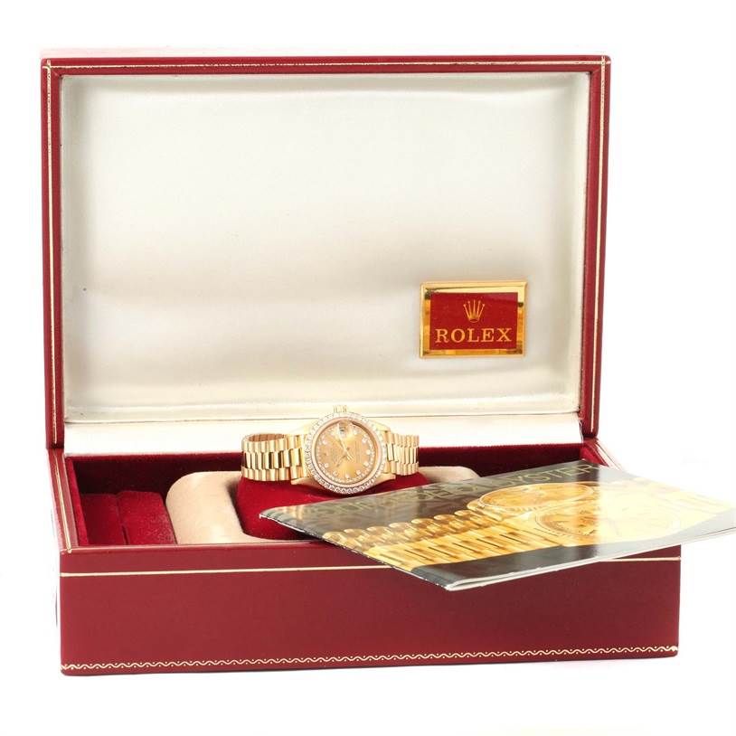 The image shows a Rolex President 69138 Women's Yellow Gold Champagne Dial 69138 Women's Yellow Gold Champagne Dial watch displayed inside its open box, along with accompanying documentation.