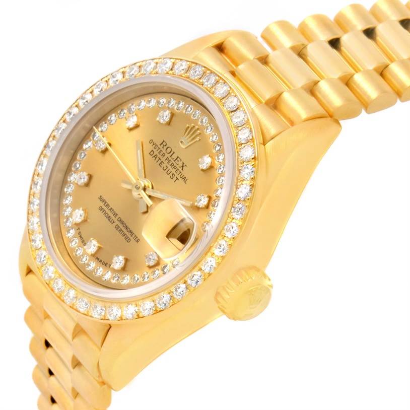 The image shows a close-up, angled view of the Rolex President 69138 Women's Yellow Gold Champagne Dial 69138 Women's Yellow Gold Champagne Dial model watch, highlighting its gold case, diamond bezel, and bracelet.