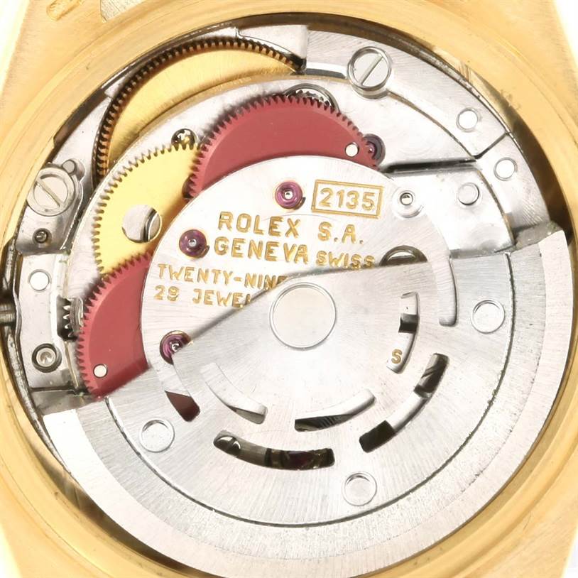 The image shows an internal view of the movement mechanism of the Rolex President 69138 Women's Yellow Gold Champagne Dial 69138 Women's Yellow Gold Champagne Dial model watch, showcasing gears and the rotor.