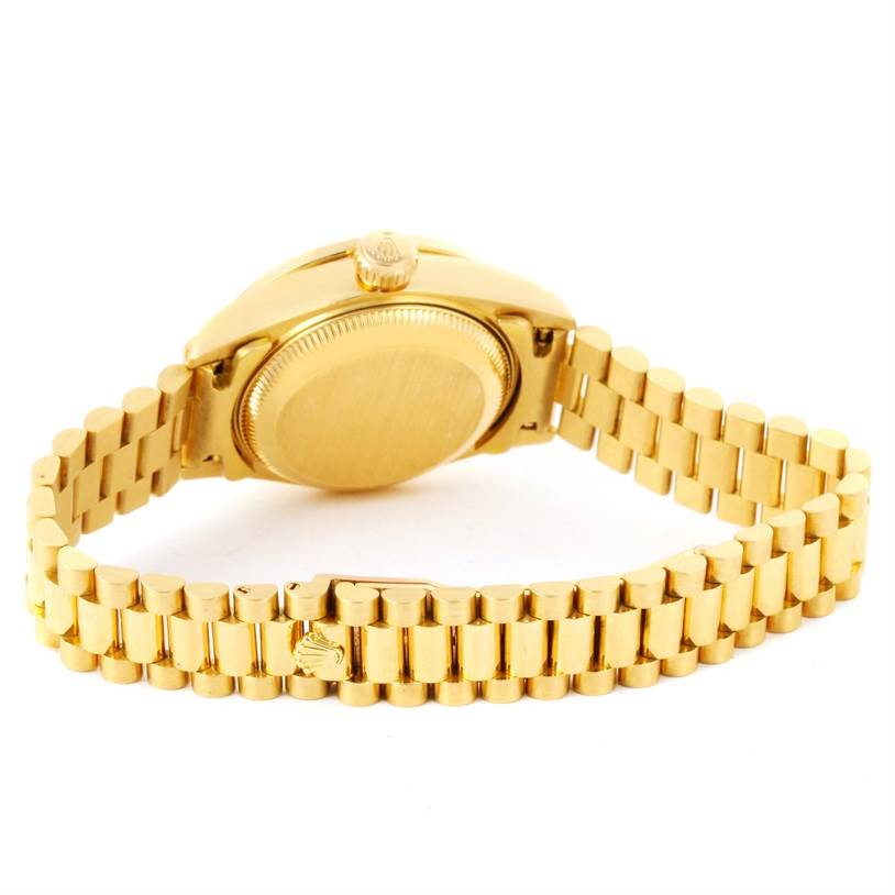 This image shows the back of a Rolex President 79138 Women's Yellow Gold Silver Dial 79138 Women's Yellow Gold Silver Dial model watch, highlighting the case back and the gold bracelet with the clasp.