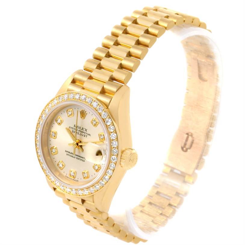 The Rolex President 79138 Women's Yellow Gold Silver Dial 79138 Women's Yellow Gold Silver Dial model watch is shown at a slight angle, displaying its gold bracelet, diamond-encrusted bezel, and dial.