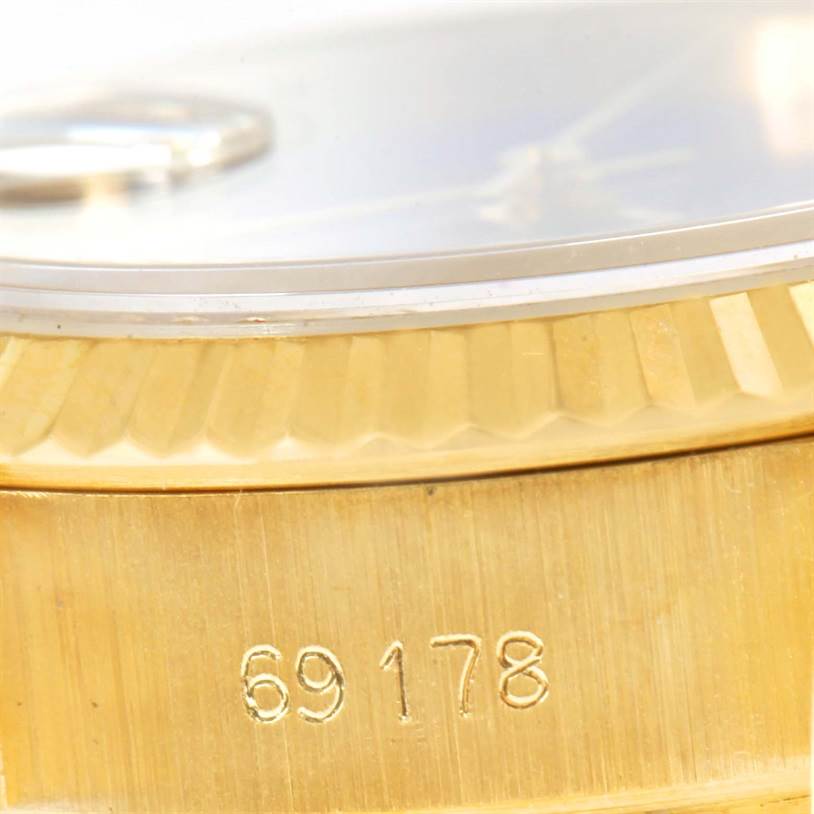 The image shows a close-up of the bezel and part of the case with the serial number of a Rolex President 69178 Women's Yellow Gold Blue Dial 69178 Women's Yellow Gold Blue Dial model watch.