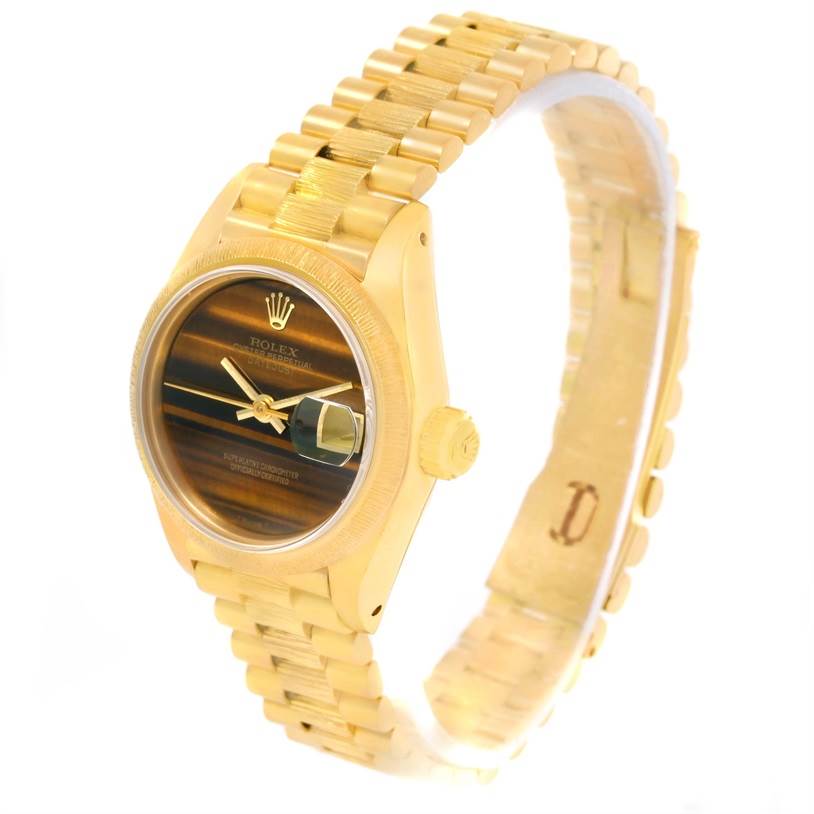 The image shows a Rolex President 69278 Women's Yellow Gold Brown Dial 69278 Women's Yellow Gold Brown Dial model watch at an angled view, highlighting its gold bracelet, case, crown, and dial with date magnifier.