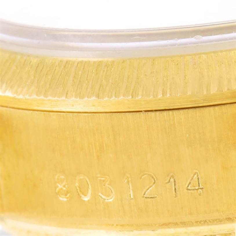 This close-up image shows the engraved serial number on the gold case of a Rolex President 69278 Women's Yellow Gold Brown Dial 69278 Women's Yellow Gold Brown Dial model watch.