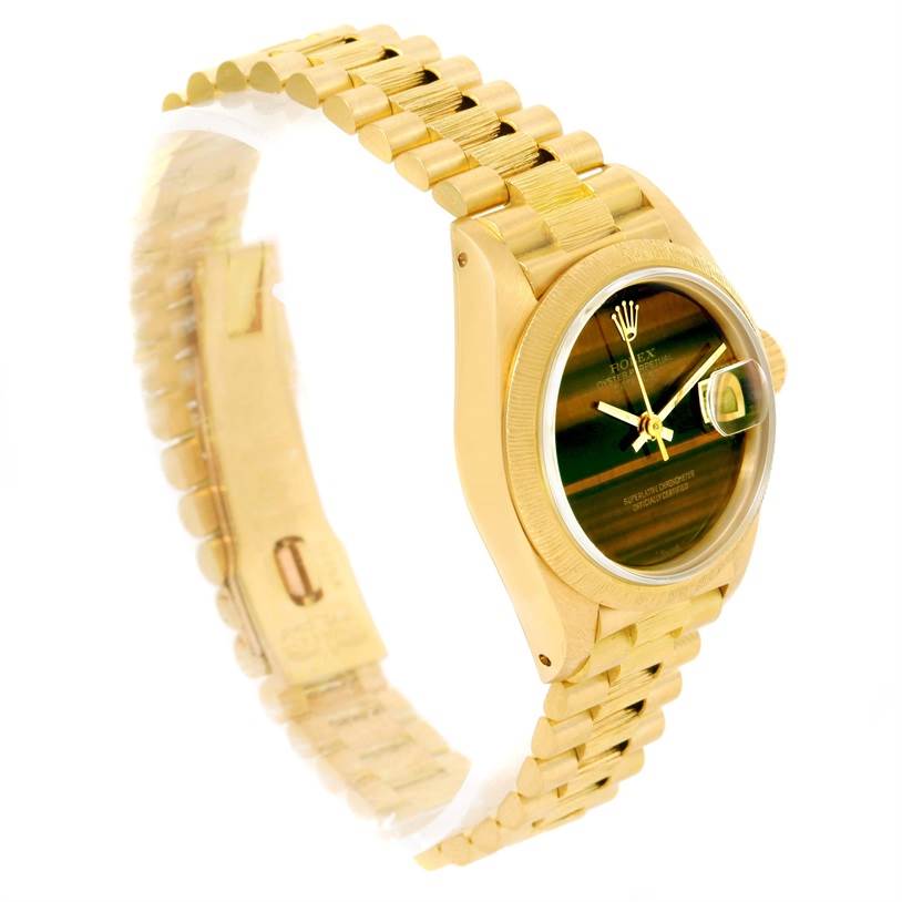 The image shows a Rolex President 69278 Women's Yellow Gold Brown Dial 69278 Women's Yellow Gold Brown Dial model watch angled from the top-left, displaying the gold bracelet, case, and dial with magnified date.