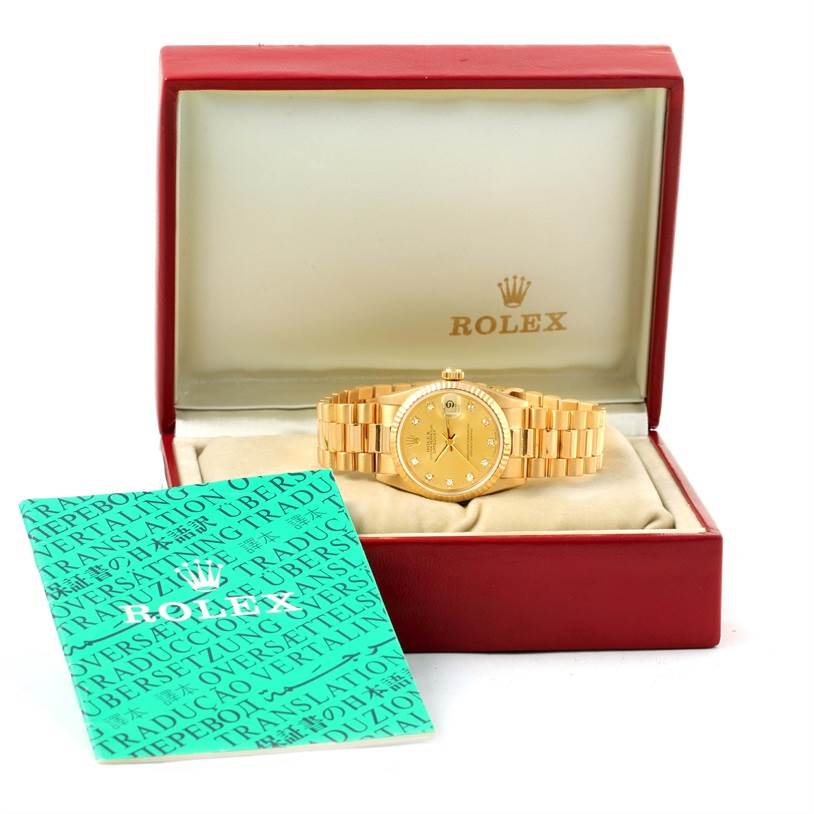 The Rolex President 68278 Women's Yellow Gold Champagne Dial 68278 Women's Yellow Gold Champagne Dial model watch is shown from the front, in its box with an accompanying booklet on the side.