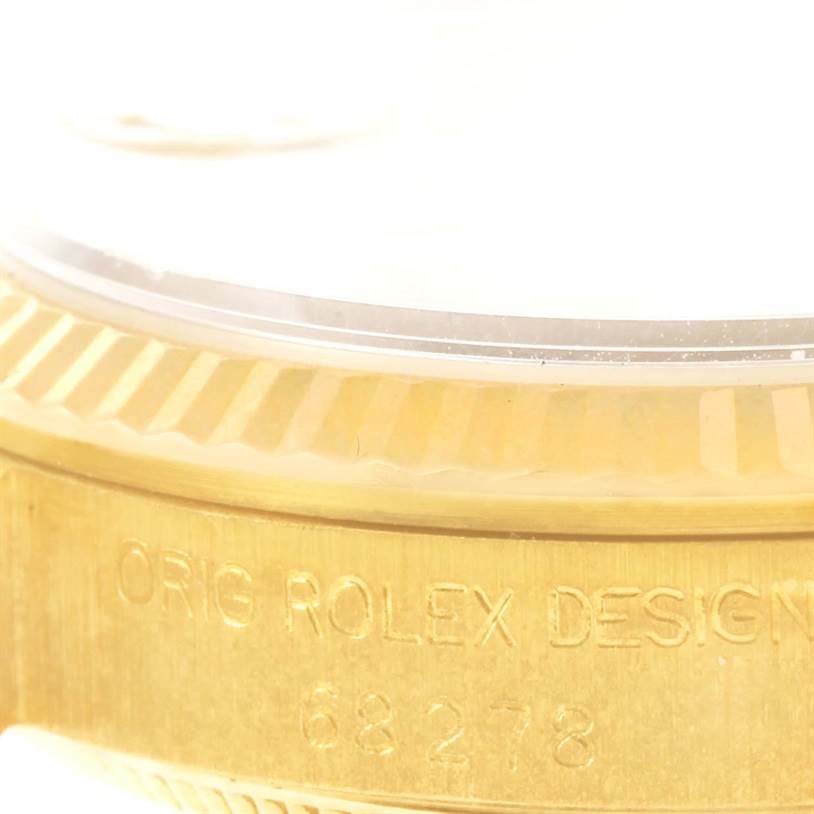 The image shows a close-up of the side of a Rolex President 68278 Women's Yellow Gold Champagne Dial 68278 Women's Yellow Gold Champagne Dial watch, highlighting the bezel and engraved model number.