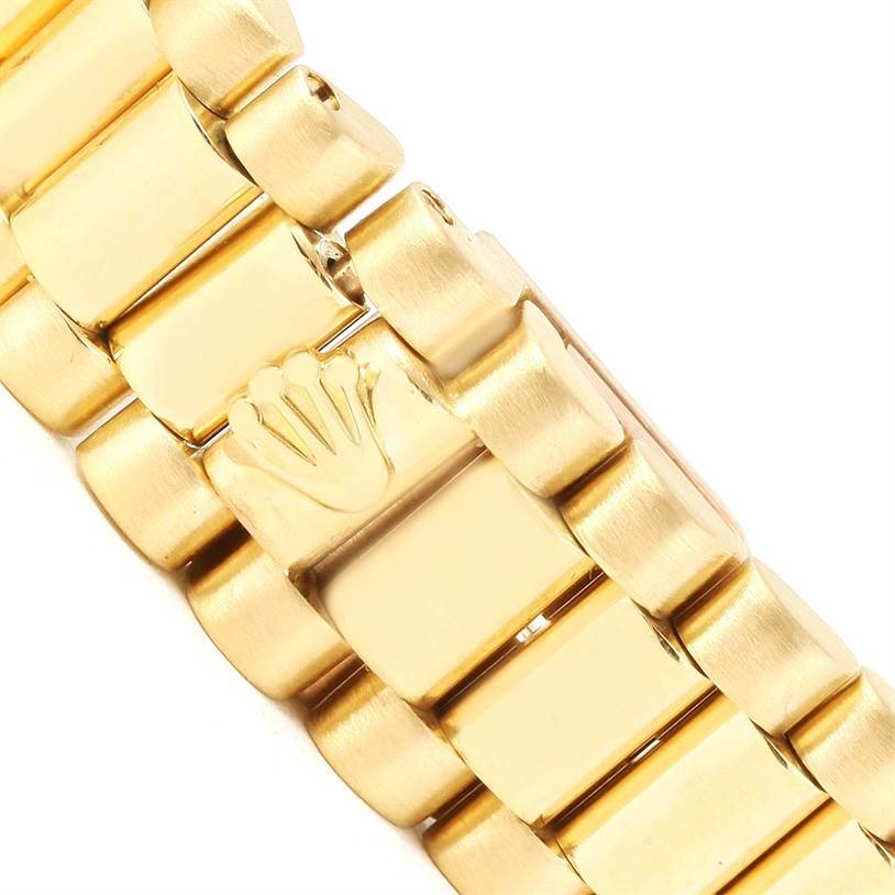 The image shows a close-up view of the gold bracelet of a Rolex President 79178 Women's Yellow Gold Silver Dial 79178 Women's Yellow Gold Silver Dial model watch, including the crown logo.