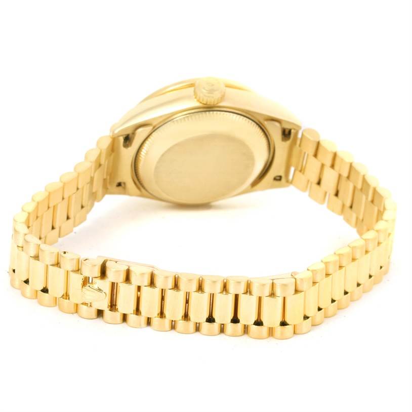 The image shows the back of a Rolex President 69178 Women's Yellow Gold Black Dial 69178 Women's Yellow Gold Black Dial model watch, highlighting the case back and gold bracelet.