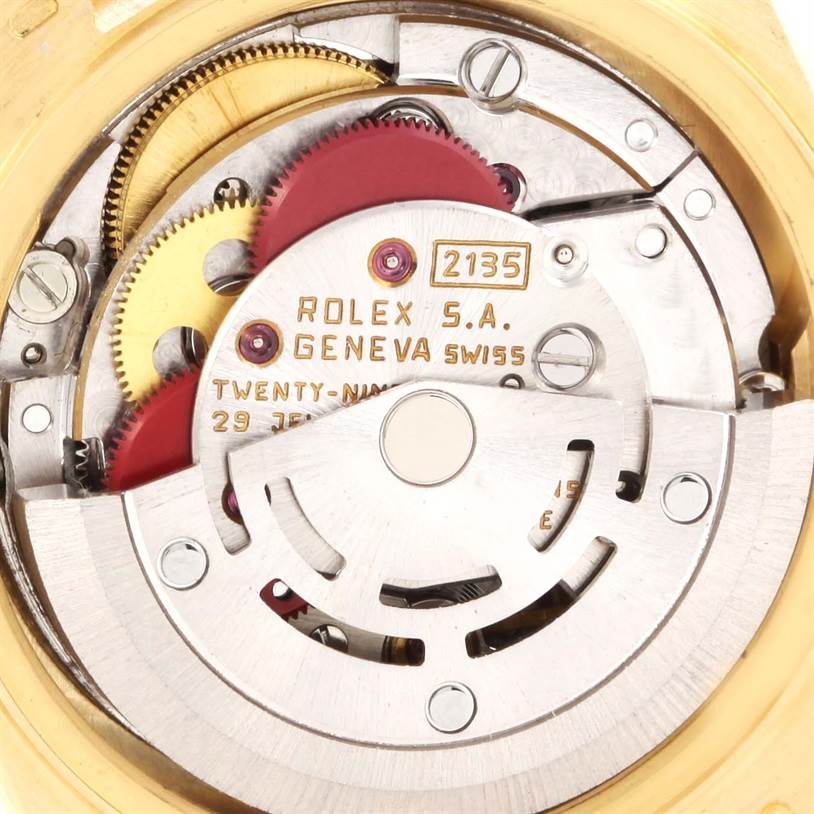 This close-up image shows the inner mechanical movement of the Rolex President 69158 Women's Yellow Gold Silver Dial 69158 Women's Yellow Gold Silver Dial model watch, highlighting gears and intricate components.