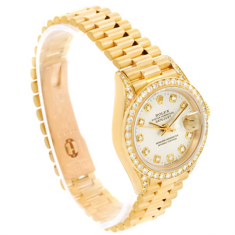 The Rolex President 69158 Women's Yellow Gold Silver Dial 69158 Women's Yellow Gold Silver Dial watch is shown at an angled side view, featuring its gold bracelet, diamond bezel, and dial with date display.