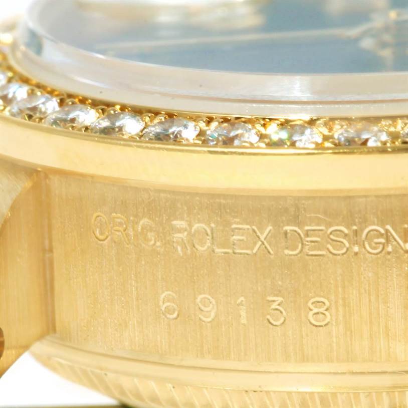This close-up image shows the case side and diamond bezel of a Rolex President 69138 Women's Yellow Gold Blue Dial 69138 Women's Yellow Gold Blue Dial model watch.