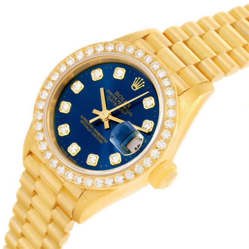 The image shows a Rolex President 69138 Women's Yellow Gold Blue Dial 69138 Women's Yellow Gold Blue Dial model watch angled to highlight its face, bezel, crown, and bracelet.
