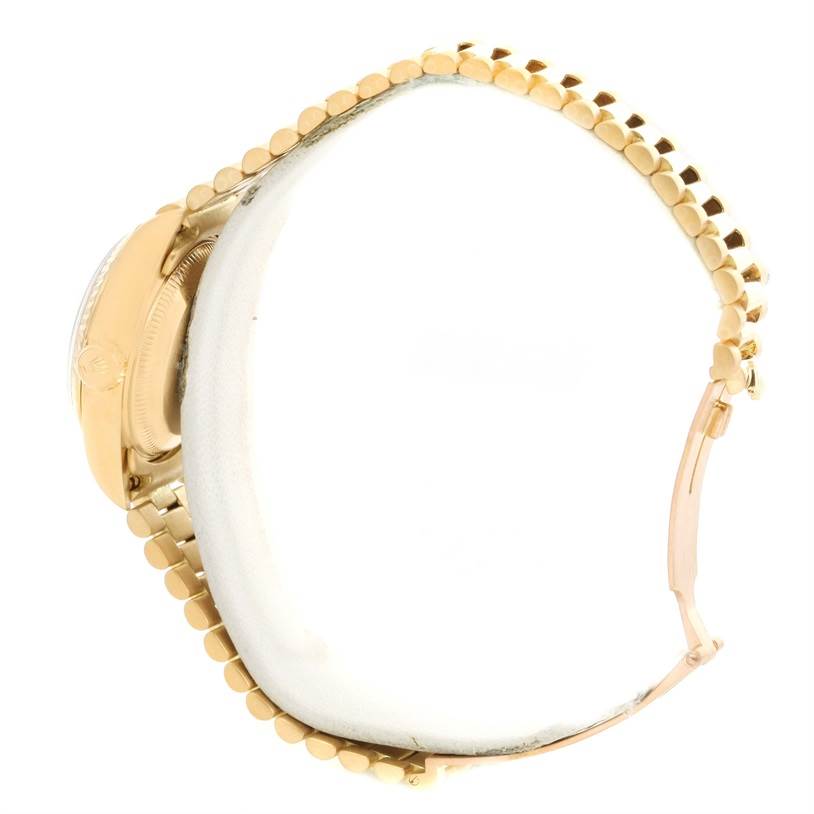 This image shows the side view and part of the bracelet of a Rolex President 69178 Women's Yellow Gold Champagne Dial 69178 Women's Yellow Gold Champagne Dial model watch.