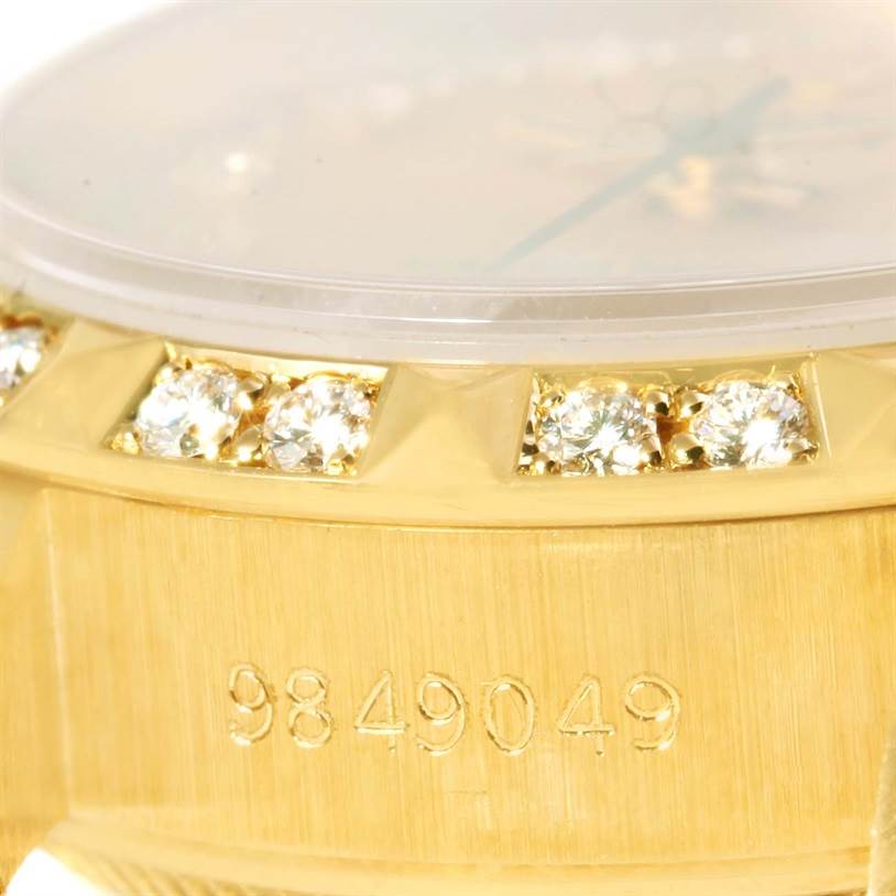 This close-up image shows the side of the Rolex President 69258 Women
s Champagne Dial 69258 Women
s Champagne Dial watch, highlighting its diamond-studded bezel and serial number.