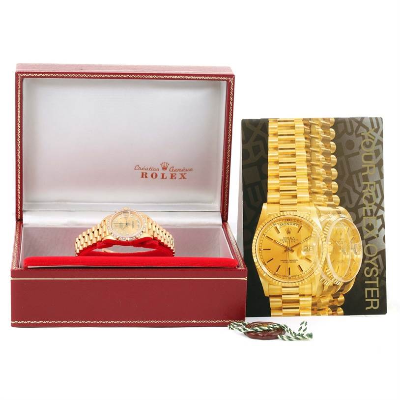The Rolex President 69258 Women
s Champagne Dial 69258 Women
s Champagne Dial model watch is shown front-facing in its box with a booklet and tag beside it.