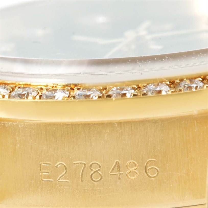 The image shows a close-up of the side of a Rolex President 69178 Women's Yellow Gold Black Dial 69178 Women's Yellow Gold Black Dial model watch, highlighting the serial number and diamond-set bezel.