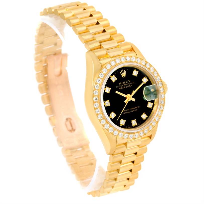 The image shows a Rolex President 69178 Women's Yellow Gold Black Dial 69178 Women's Yellow Gold Black Dial model watch at a three-quarter angle, highlighting the gold bracelet, black dial, and diamond bezel.