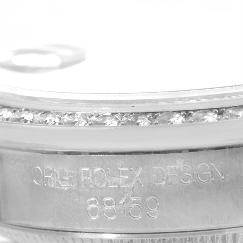 The image shows a close-up of the side view of a Rolex President 68159 Women's White Gold Mother of Pearl Dial 68159 Women's White Gold Mother of Pearl Dial model, focusing on the bezel, diamond setting, and model number.