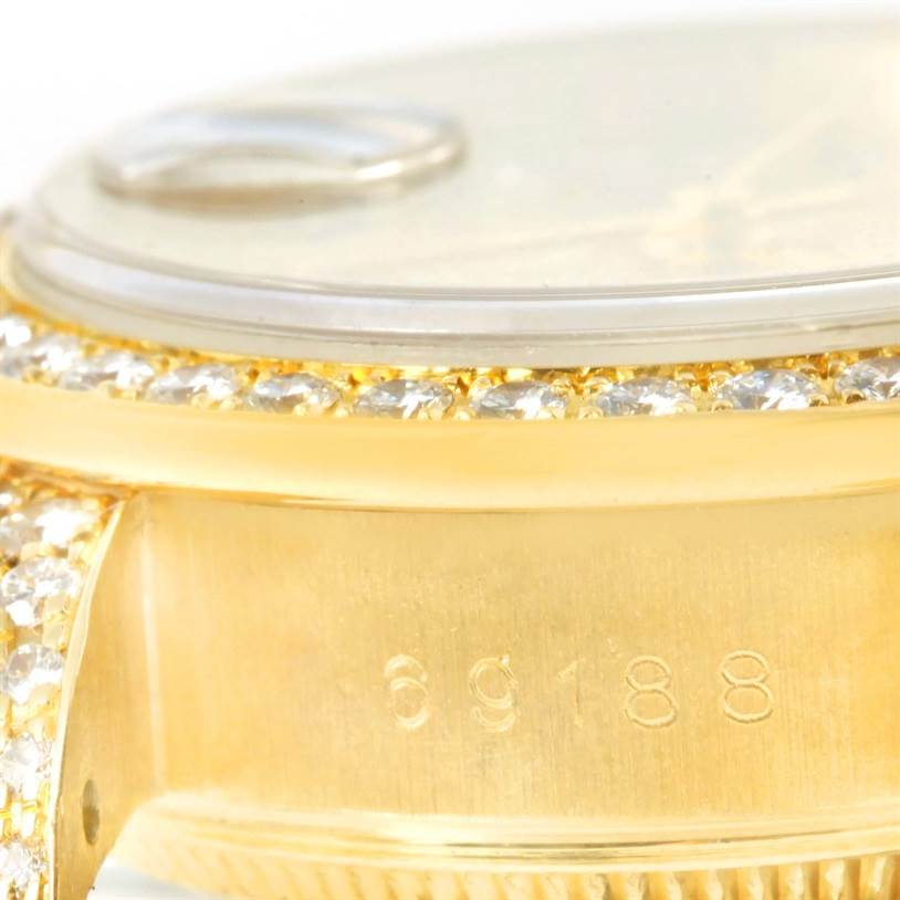 This close-up image shows part of the bezel and case with a serial number on the Rolex President 69188 Women's Yellow Gold Champagne Dial 69188 Women's Yellow Gold Champagne Dial model watch.