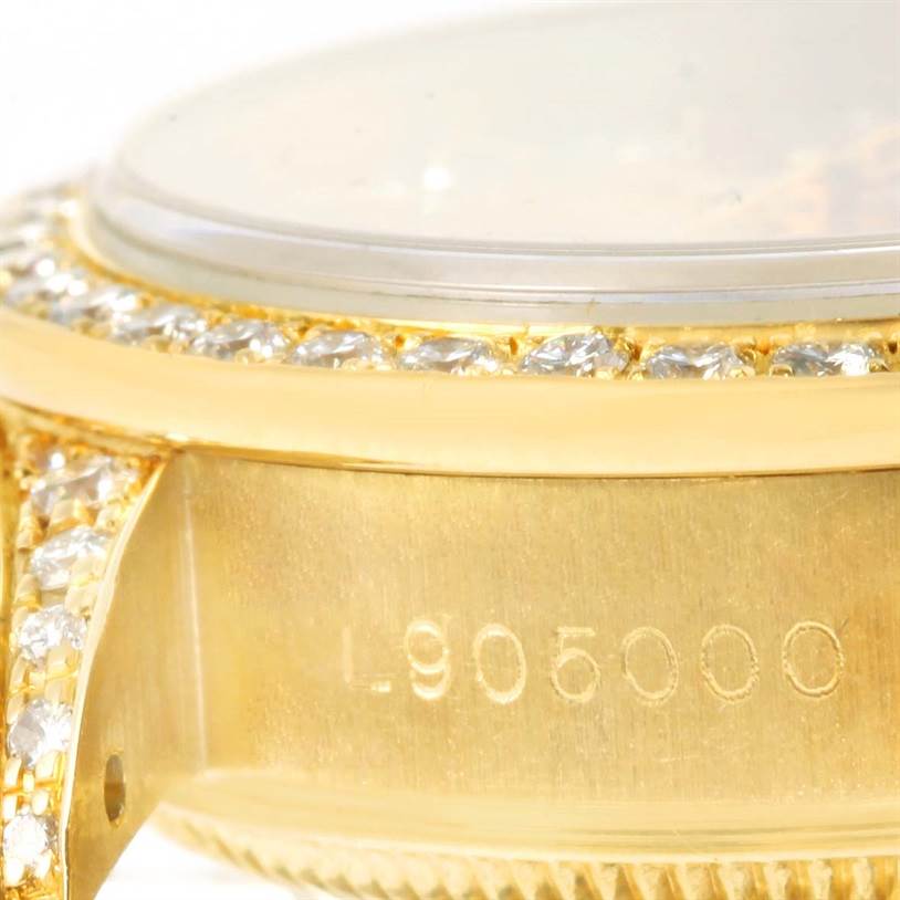This close-up image of the Rolex President 69188 Women's Yellow Gold Champagne Dial 69188 Women's Yellow Gold Champagne Dial watch focuses on part of the case, bezel, and part of the serial number.
