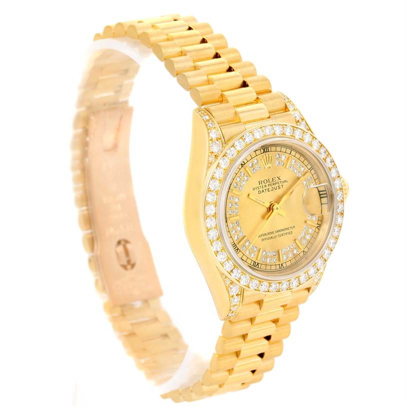 The image shows a Rolex President 69188 Women's Yellow Gold Champagne Dial 69188 Women's Yellow Gold Champagne Dial model watch angled to display its gold bracelet, diamond-encrusted bezel, and dial.