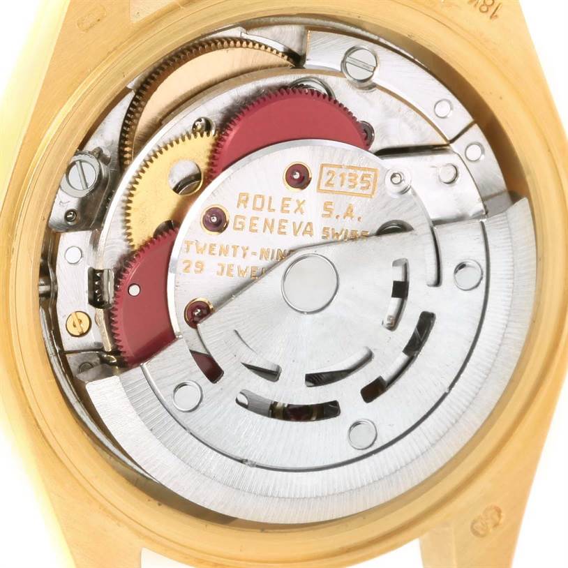 This image shows the movement mechanism of a Rolex President 69178 Women's Yellow Gold White Dial 69178 Women's Yellow Gold White Dial watch, viewed from the back, highlighting gears and the automatic rotor.