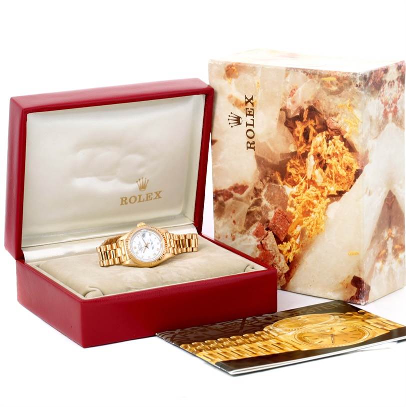 The image shows a Rolex President 69178 Women's Yellow Gold White Dial 69178 Women's Yellow Gold White Dial model watch in its box with the outer packaging and accompanying booklet.