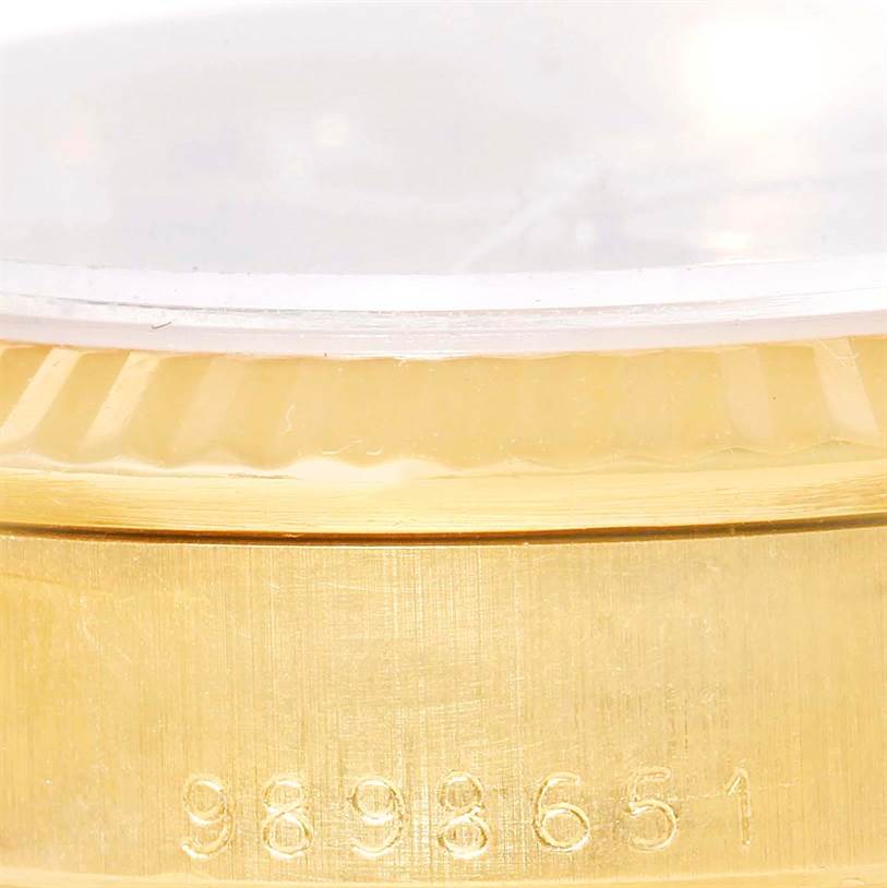 The image shows a close-up of the case and bezel of a Rolex President 68278 Women's Yellow Gold Champagne Dial 68278 Women's Yellow Gold Champagne Dial model, revealing part of its serial number.