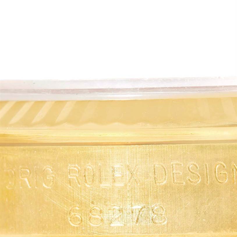 This close-up image of the Rolex President 68278 Women's Yellow Gold Champagne Dial 68278 Women's Yellow Gold Champagne Dial model shows the side of the watch case with etched design and model number.